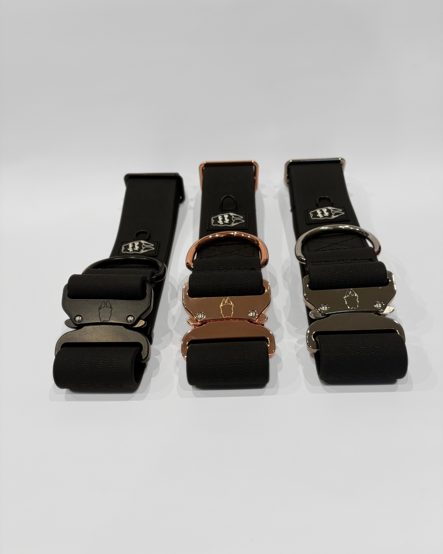 Black, cherry wine, and cactus green 2-inch waterproof PVC dog collars with visible buckles, displayed side by side on a light gray background.