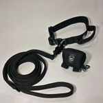 Black dog collar, matching nylon leash, and portable poop bag dispenser set displayed on a white background.
