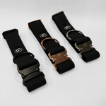 Black 2-inch waterproof PVC dog collars with black, silver, and rose gold hardware, displayed at an angle with visible buckles on a light gray background.