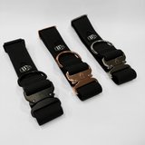Black 2-inch waterproof PVC dog collars with black, silver, and rose gold hardware, displayed at an angle with visible buckles on a light gray background.