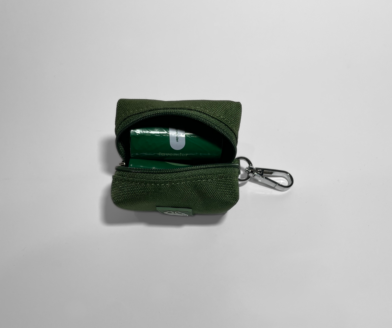 Cactus green portable poop bag dispenser with two rolls of poop bags, displayed on a white background.