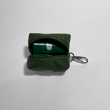 Cactus green portable poop bag dispenser with two rolls of poop bags, displayed on a white background.