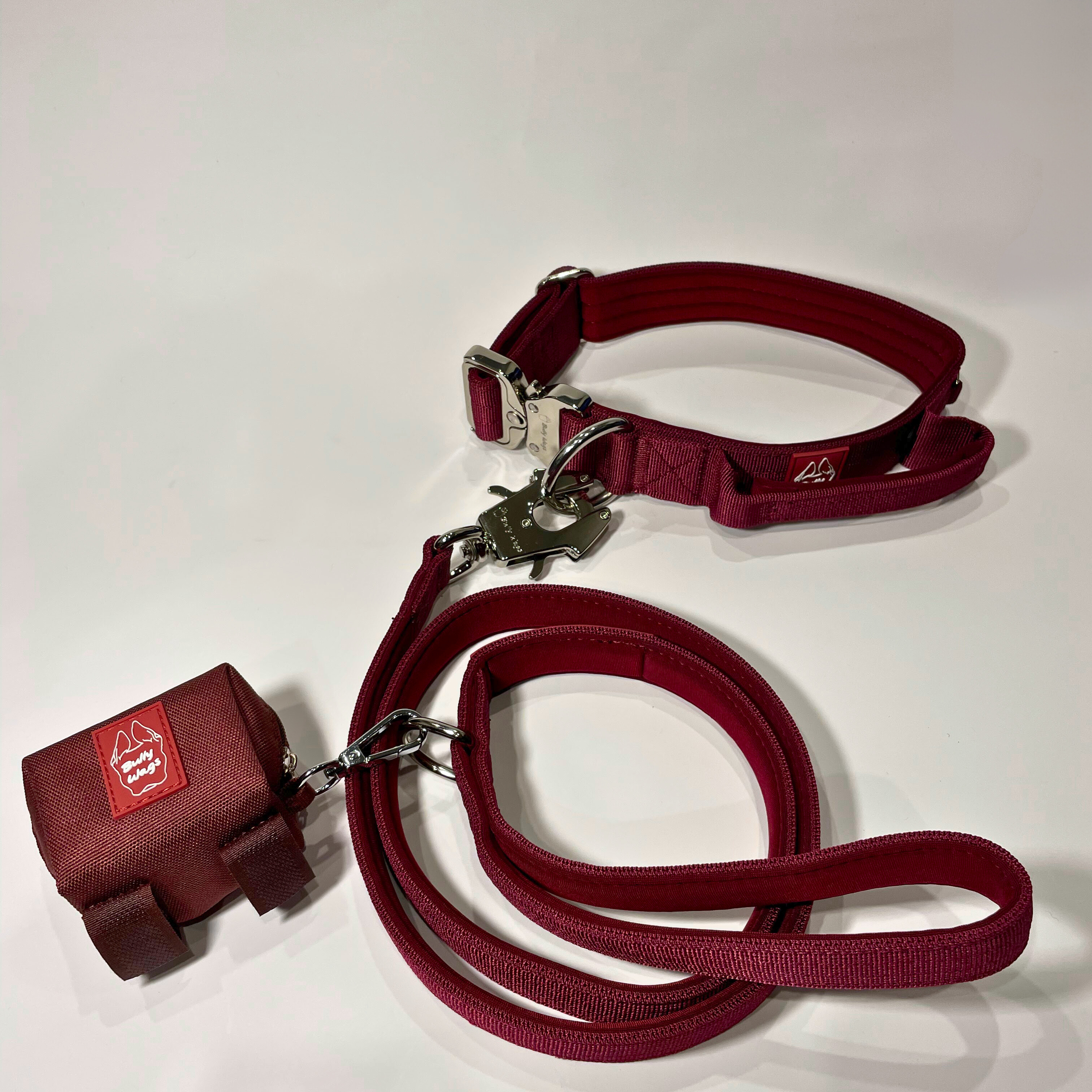 Cherry wine dog collar, matching nylon leash, and portable poop bag dispenser set displayed on a white background.