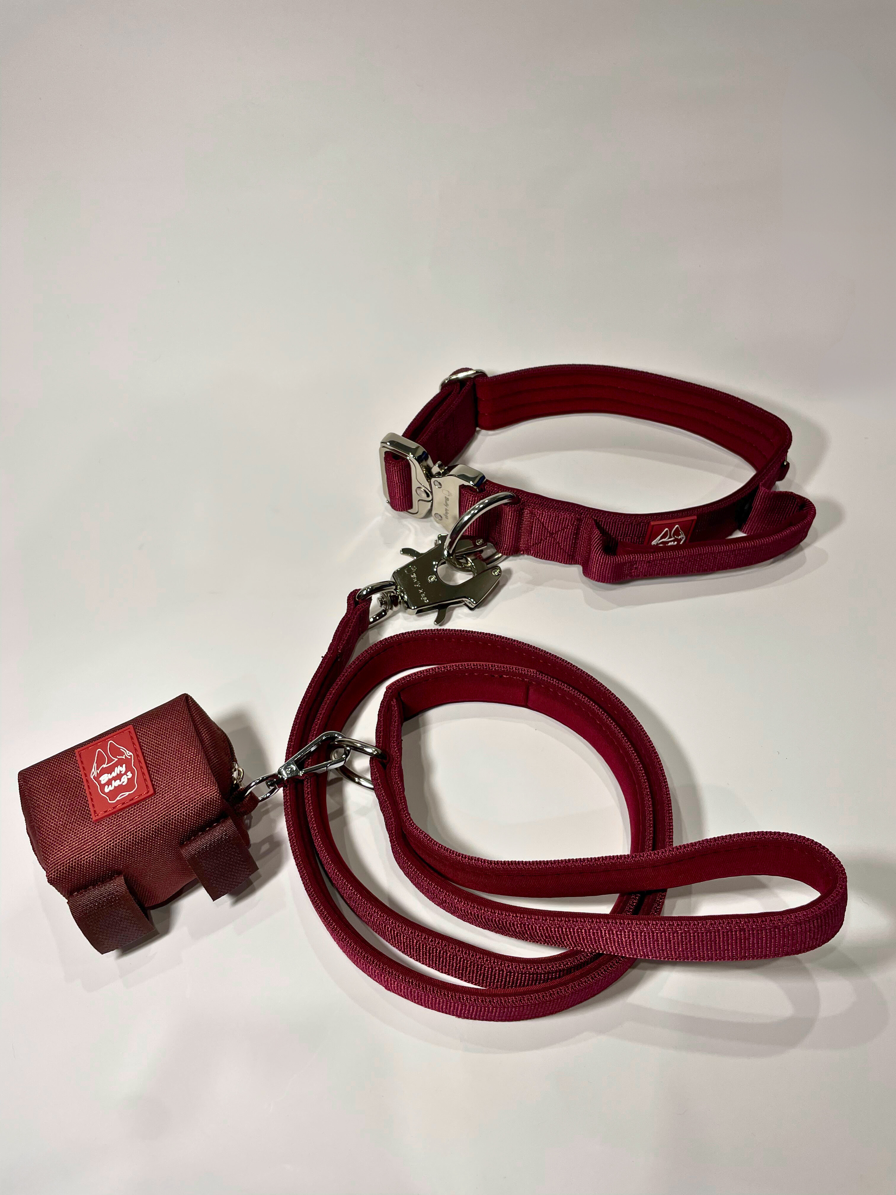 Cherry wine dog collar, matching nylon leash, and portable poop bag dispenser set displayed on a white background.