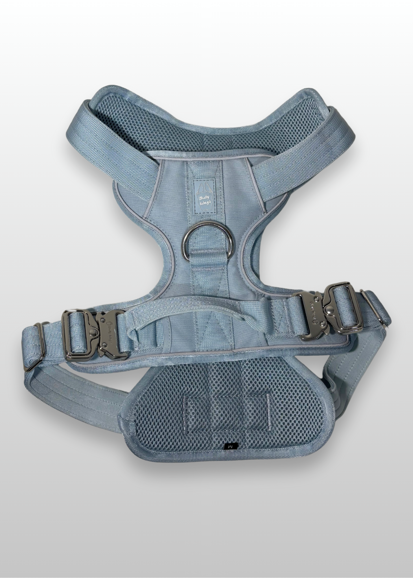Baby Blue Heavy Duty dog harness shown from above, featuring silver hardware, breathable mesh padding, adjustable straps, and reflective trim on a light gray background.