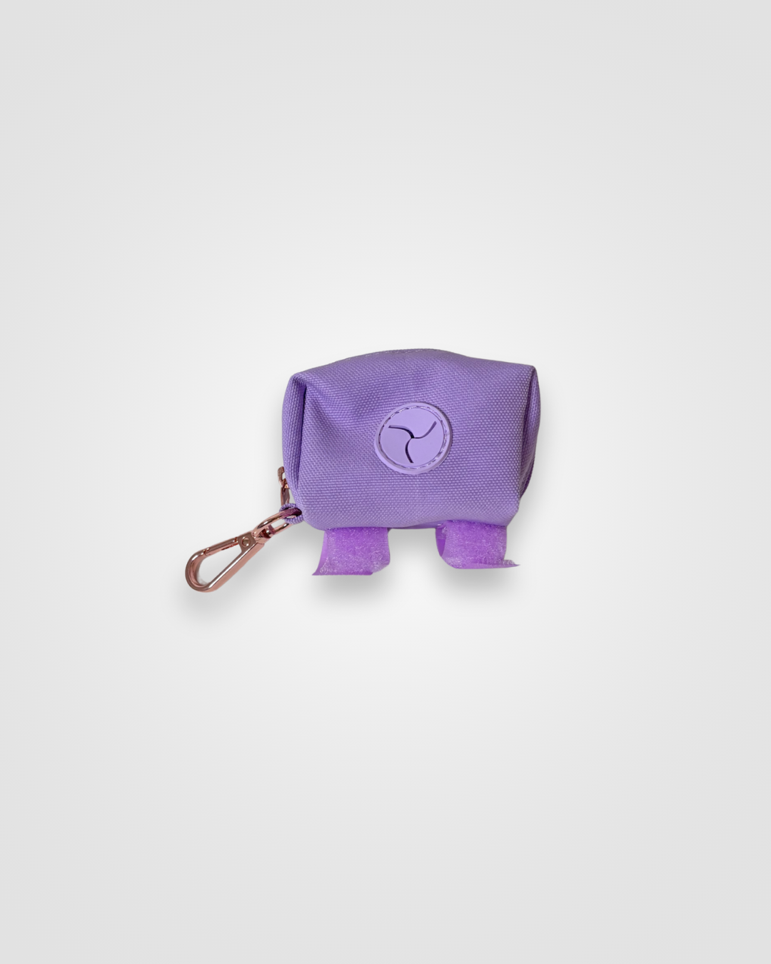 Lilac dog poop bag dispenser with carabiner displayed on a white background.