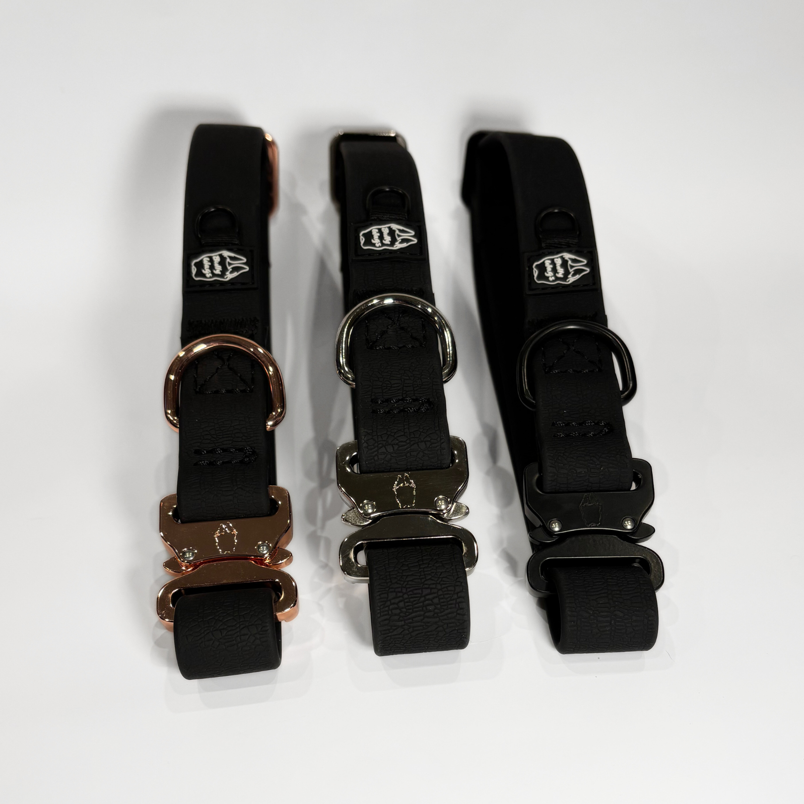 Black 1-inch waterproof PVC dog collars with rose gold, silver, and black hardware, displayed side by side on a light gray background.